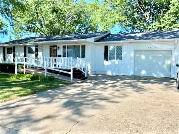 a front view of house with a garden