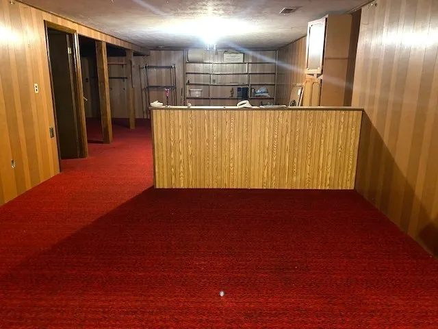 a view of a room with wooden floor