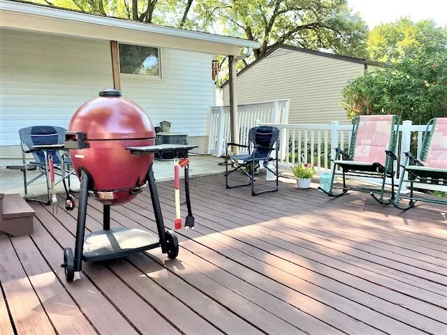a view of a deck with wooden floor and table and chairs