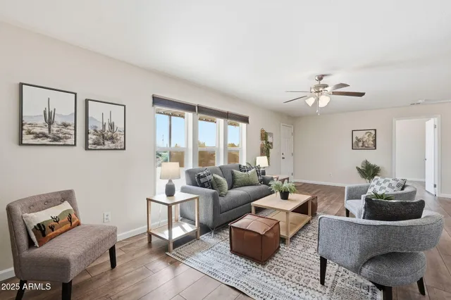 a living room with furniture and a potted plant on table
