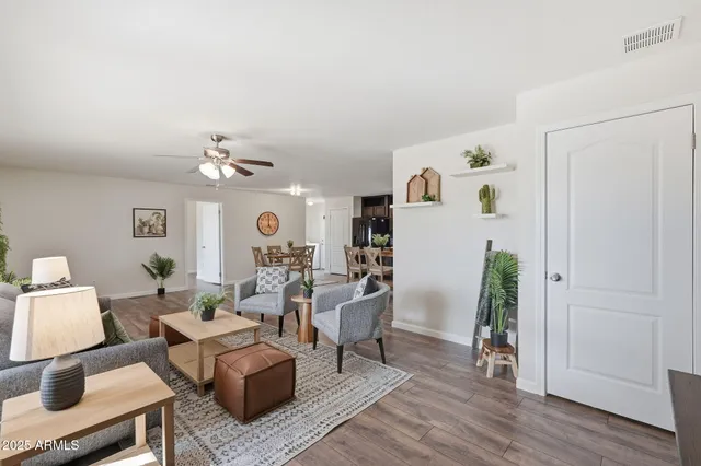 a living room with furniture and a wooden floor