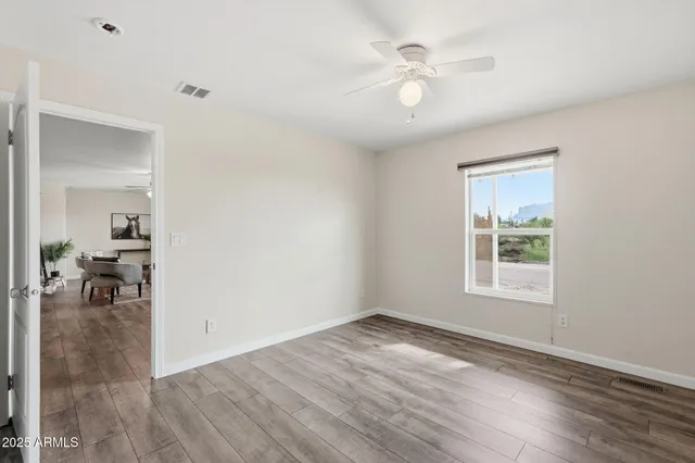 wooden floor in an empty room with a window