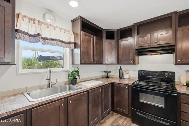 a kitchen with stainless steel appliances a sink stove and microwave