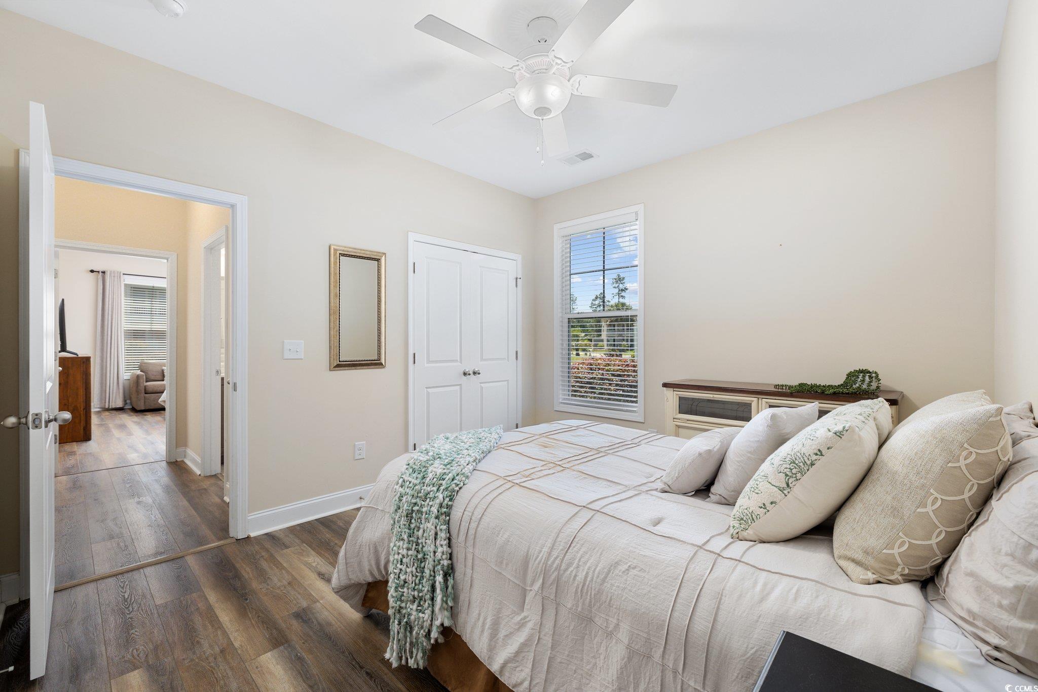 179 Hyacinth Loop Murrells Inlet, SC 29576 - Photo 16 of 40 Bedroom featuring visible vents, a closet, wood finished floors, baseboards, and a ceiling fan