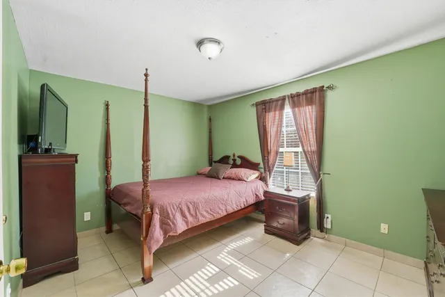 a bedroom with a bed and a mirror