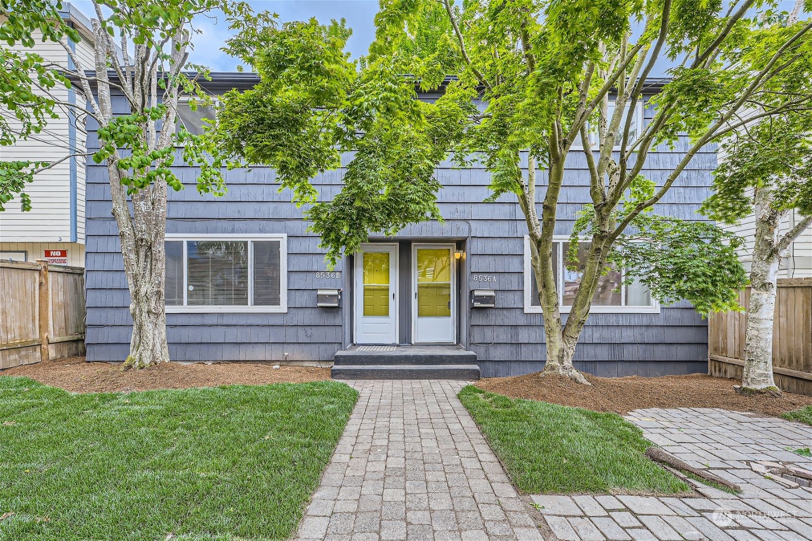 a front view of a house with a garden