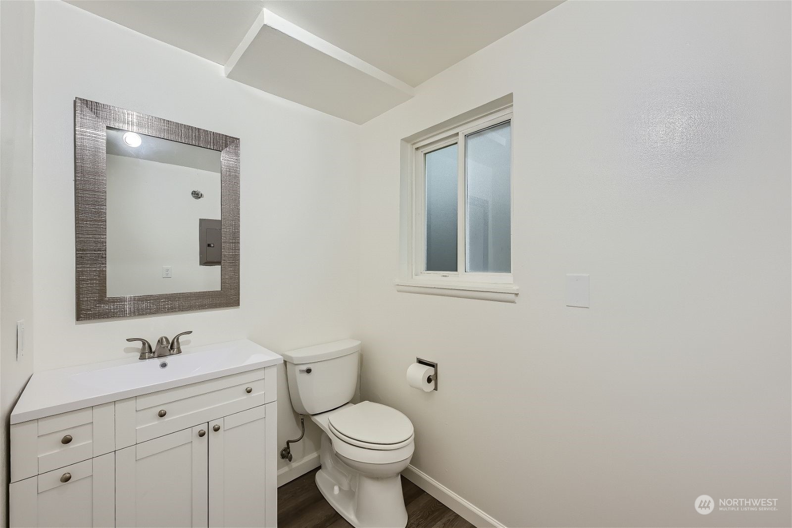 8536 Nesbit Avenue North, Unit A Seattle, WA 98103 - Photo 14 of 32 a bathroom with a toilet sink and mirror