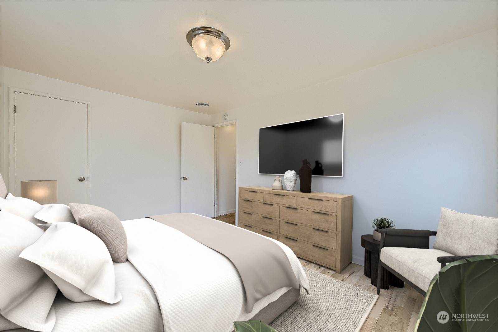 8536 Nesbit Avenue North, Unit A Seattle, WA 98103 - Photo 16 of 32 a bedroom with a bed and a flat screen tv