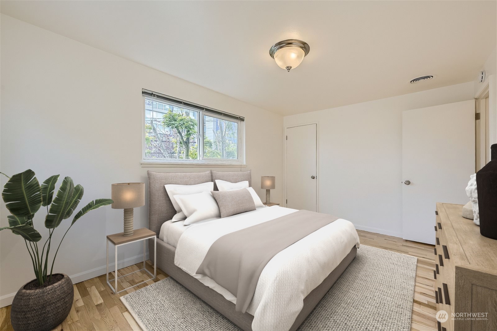 8536 Nesbit Avenue North, Unit A Seattle, WA 98103 - Photo 17 of 32 a bedroom with a bed and window