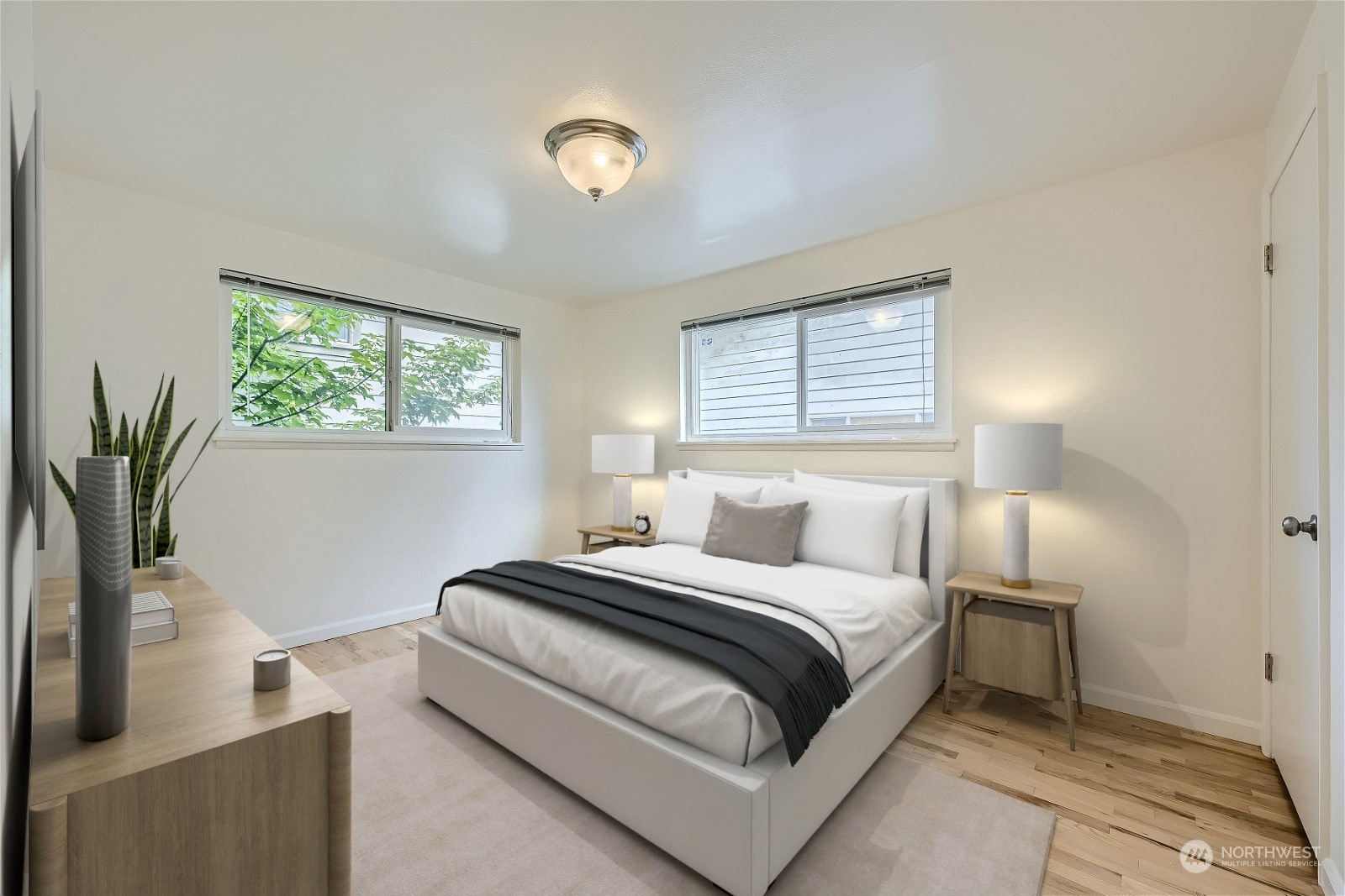8536 Nesbit Avenue North, Unit A Seattle, WA 98103 - Photo 20 of 32 a bedroom with a bed and a potted plant