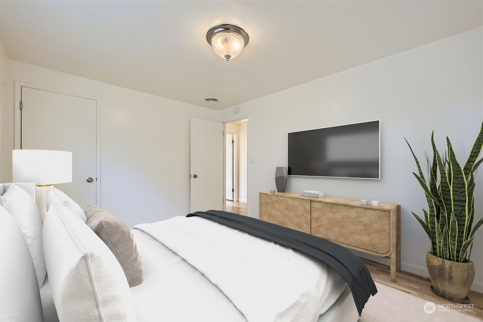 8536 Nesbit Avenue North, Unit A Seattle, WA 98103 - Photo 22 of 32 a bedroom with a bed and a flat screen tv