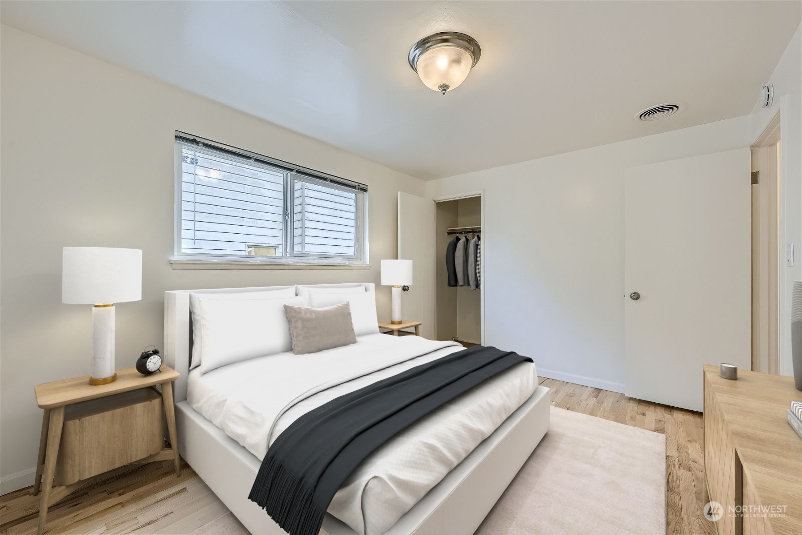 8536 Nesbit Avenue North, Unit A Seattle, WA 98103 - Photo 23 of 32 a bedroom with a bed and a lamp