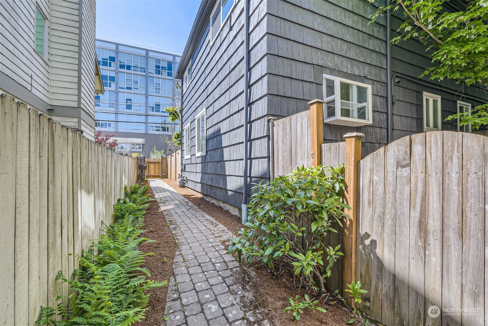 8536 Nesbit Avenue North, Unit A Seattle, WA 98103 - Photo 26 of 32 a view of a pathway of a house with backyard and plants