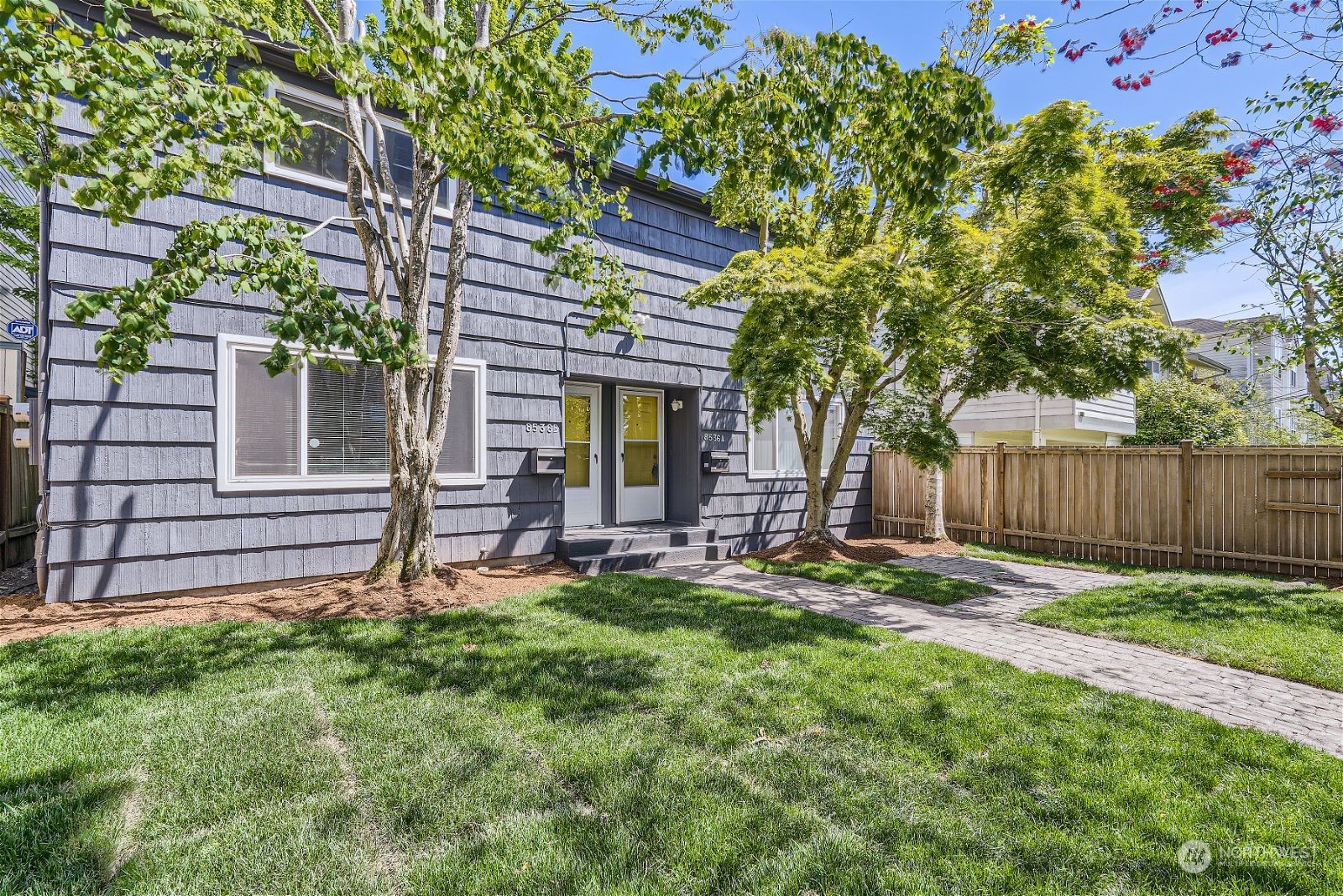 8536 Nesbit Avenue North, Unit A Seattle, WA 98103 - Photo 30 of 32 a house with a tree in front of it