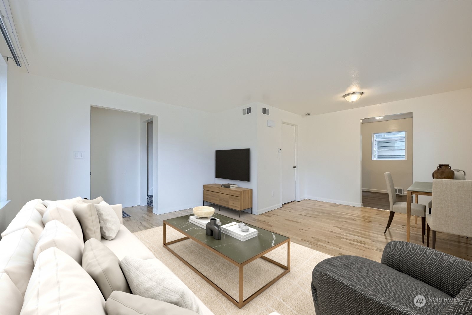 8536 Nesbit Avenue North, Unit A Seattle, WA 98103 - Photo 6 of 32 a living room with furniture and a flat screen tv