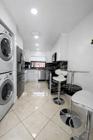 a kitchen with a cabinets and chairs
