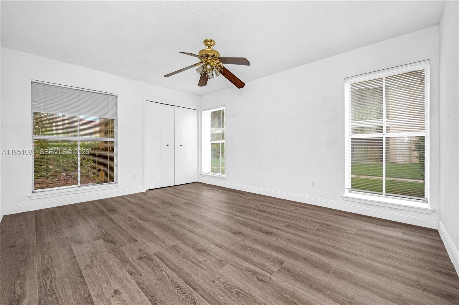 833 Riverside Drive, Unit 811 Coral Springs, FL 33071 - Photo 14 of 26 a view of empty room with wooden floor and fan