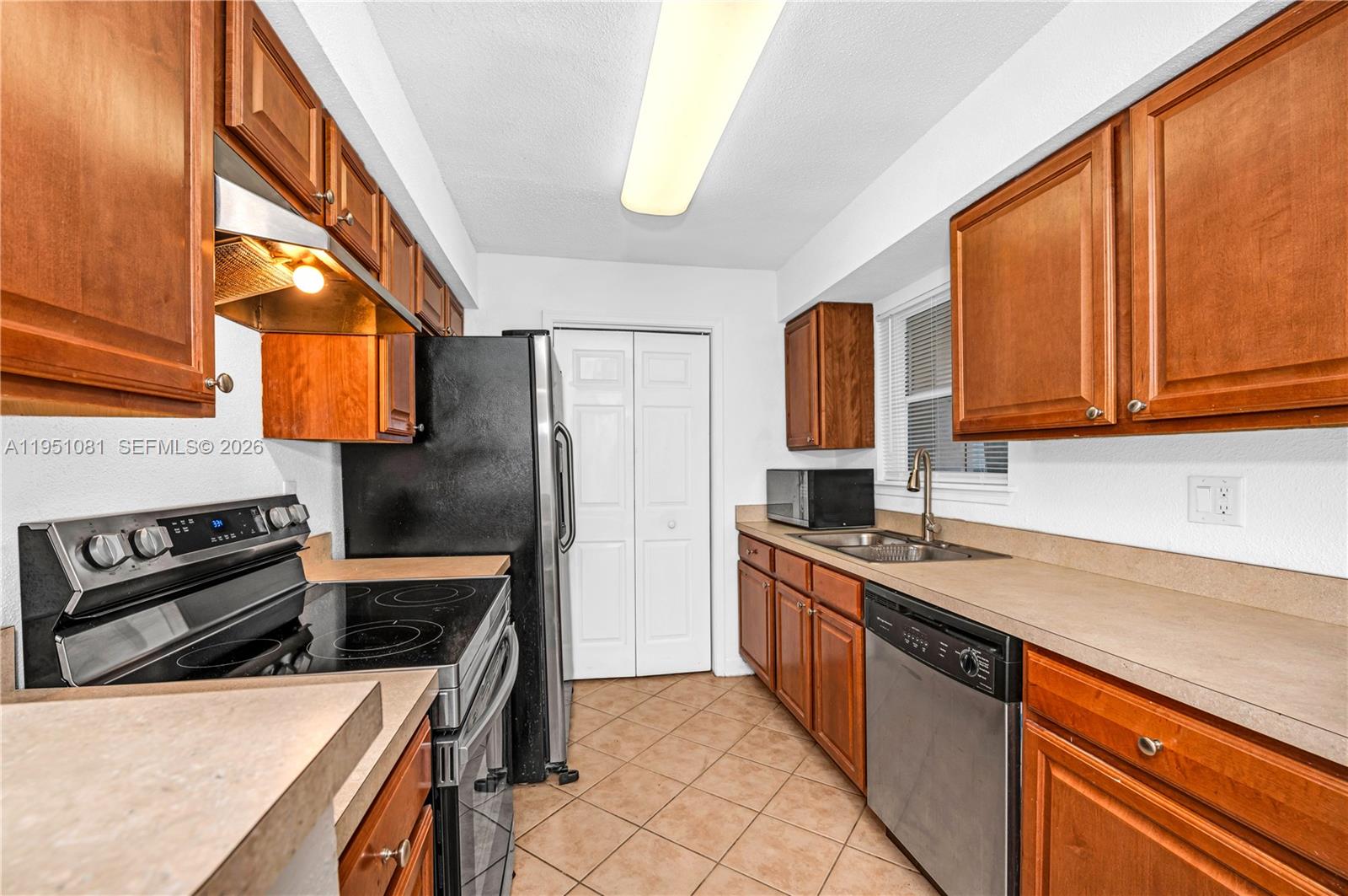 833 Riverside Drive, Unit 811 Coral Springs, FL 33071 - Photo 2 of 26 a kitchen with a stove a sink and a refrigerator