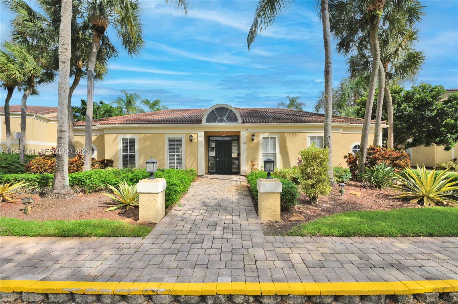 833 Riverside Drive, Unit 811 Coral Springs, FL 33071 - Photo 22 of 26 a front view of a house with garden and porch