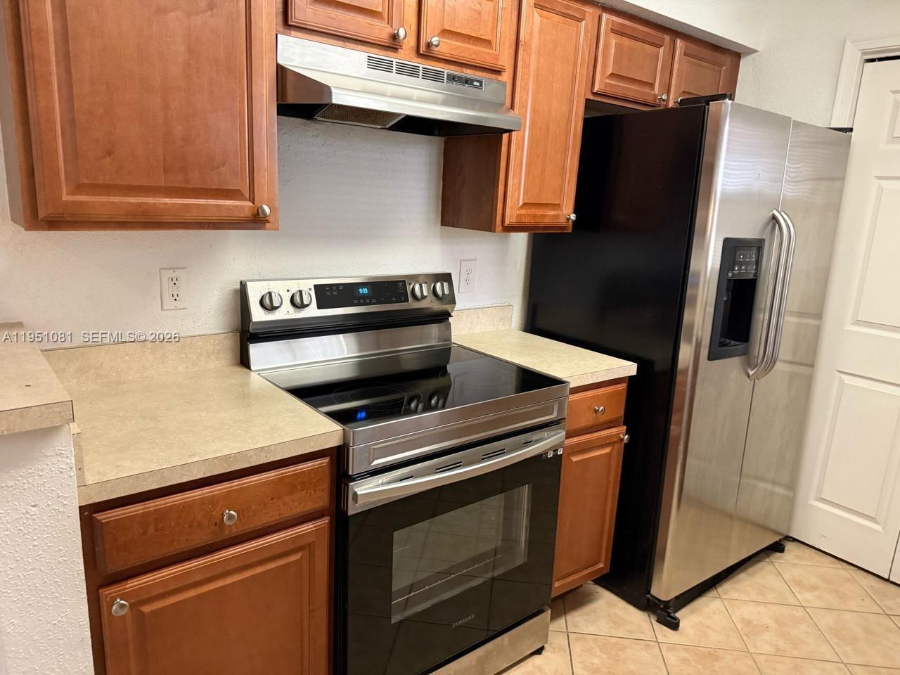 833 Riverside Drive, Unit 811 Coral Springs, FL 33071 - Photo 3 of 26 a kitchen with a stove microwave and refrigerator