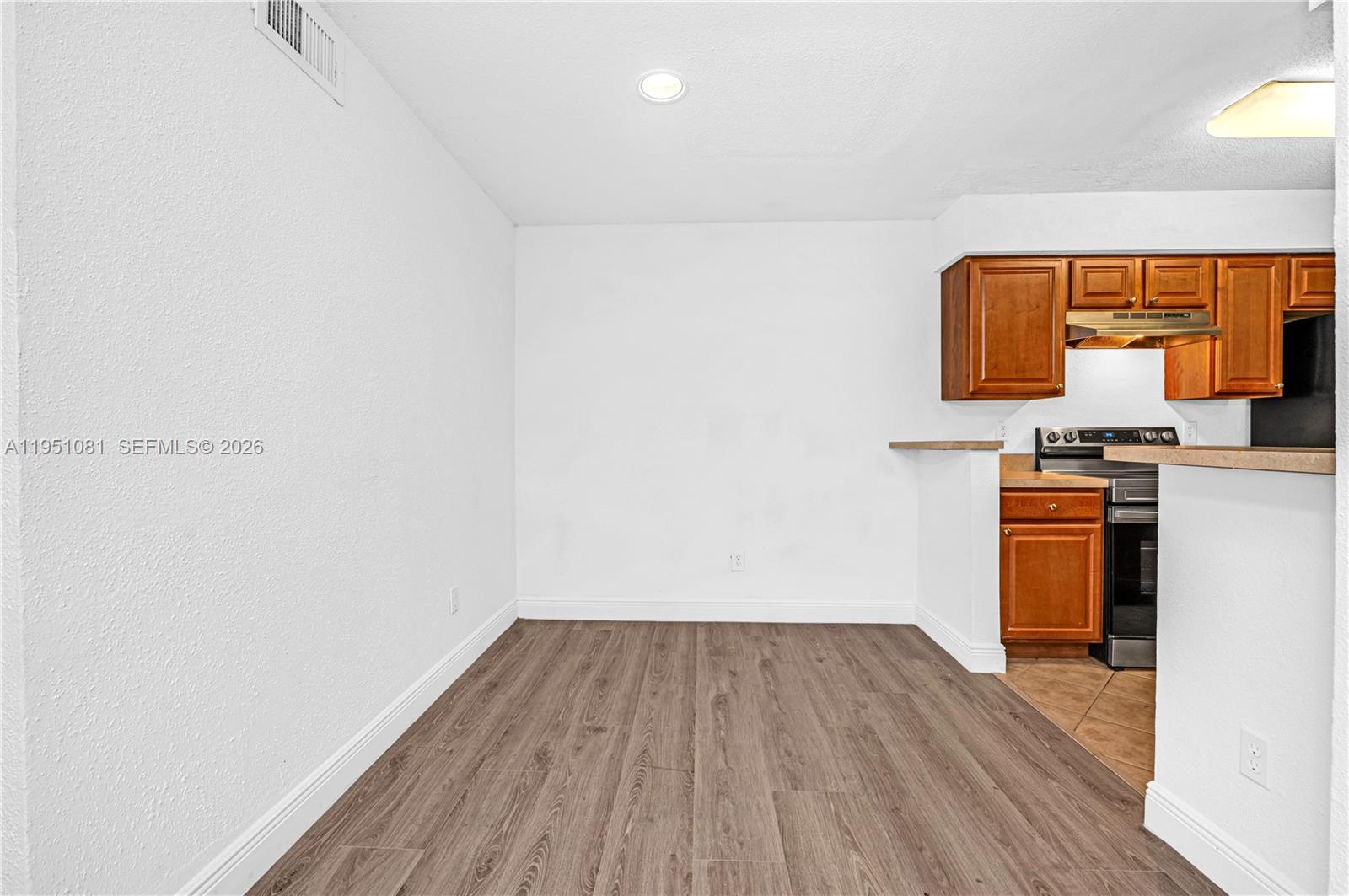 833 Riverside Drive, Unit 811 Coral Springs, FL 33071 - Photo 6 of 26 a view of kitchen with wooden floor
