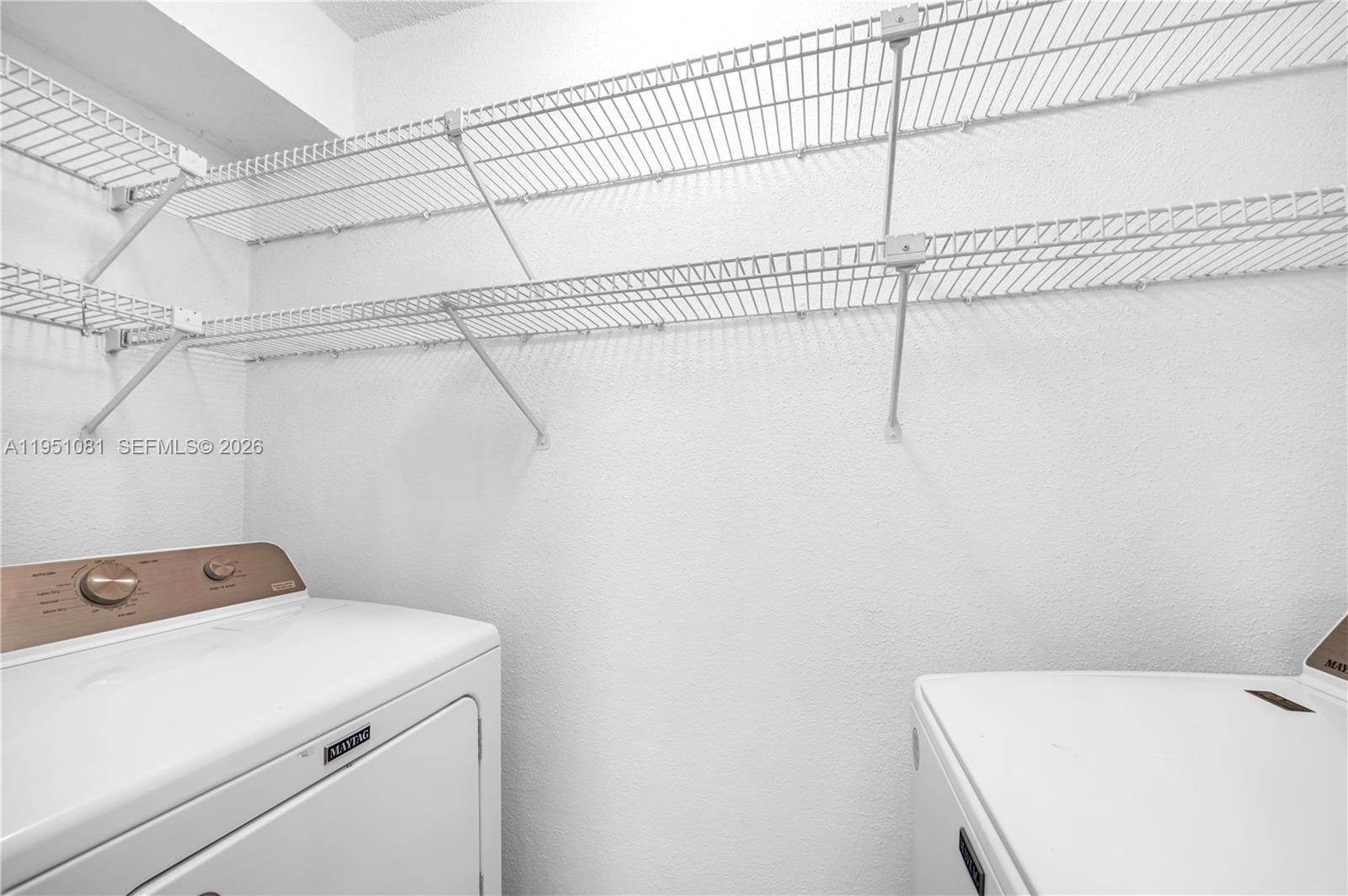 833 Riverside Drive, Unit 811 Coral Springs, FL 33071 - Photo 10 of 26 a utility room with dryer and washer