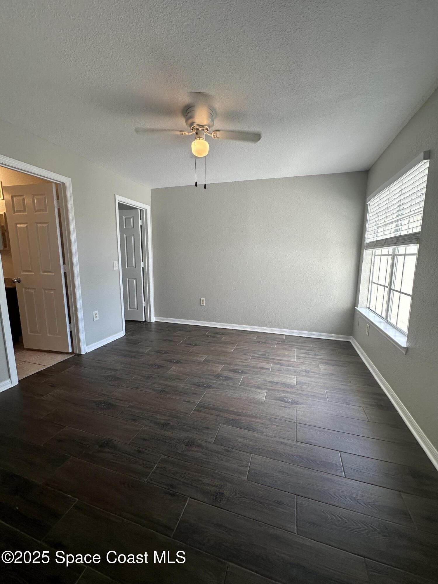 3511 D'Avinci Way, Unit 2012 Melbourne, FL 32901 - Photo 14 of 22 an empty room with wooden floor and window