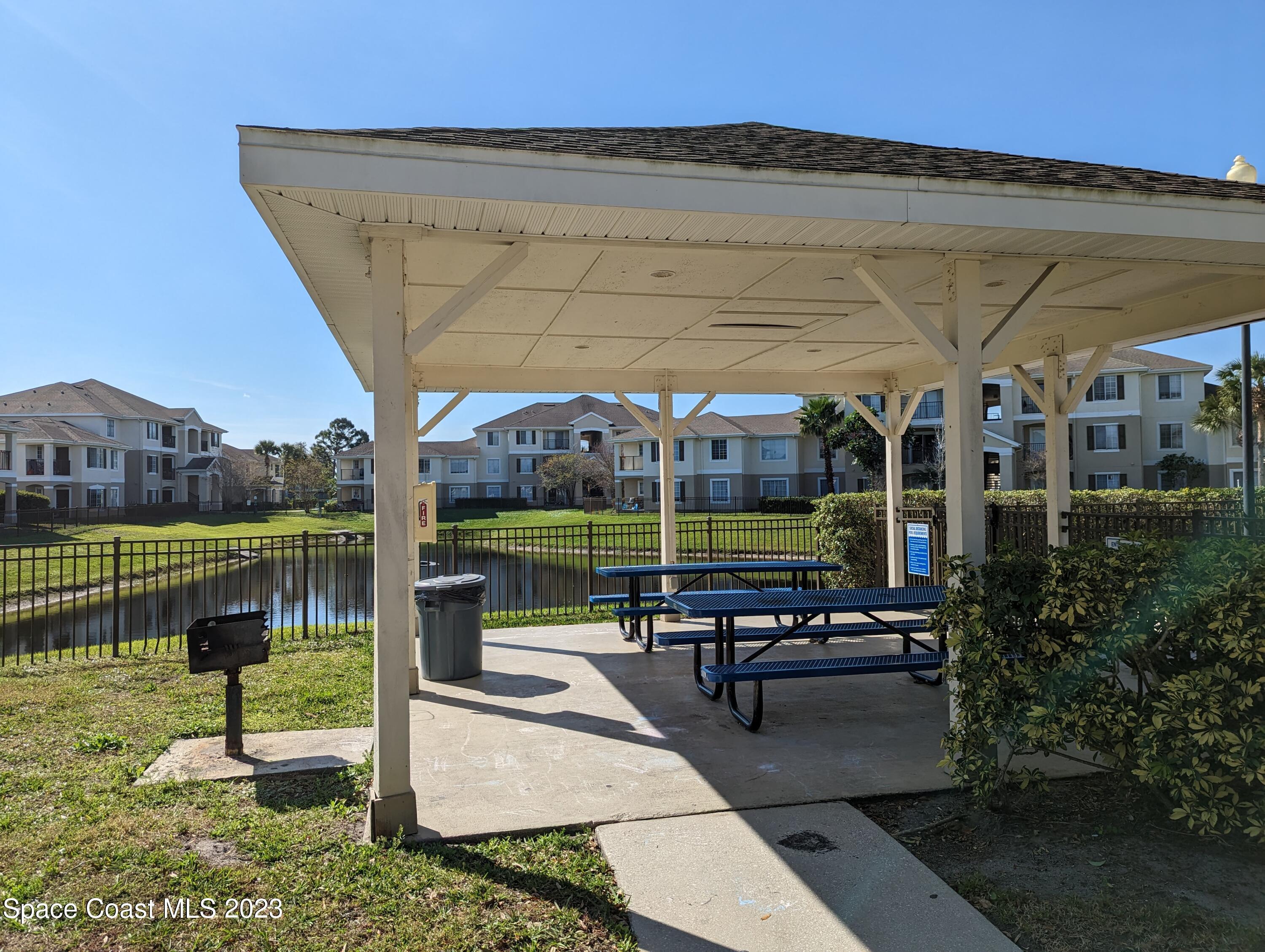 3511 D'Avinci Way, Unit 2012 Melbourne, FL 32901 - Photo 18 of 22 a view of a swimming pool with a patio and a garden