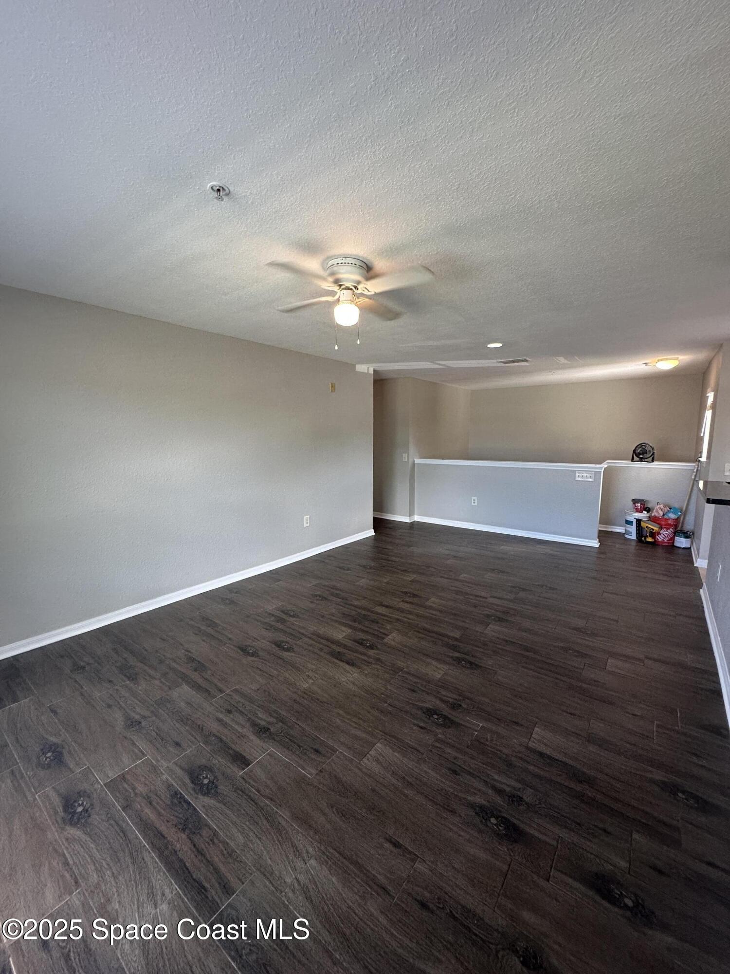 3511 D'Avinci Way, Unit 2012 Melbourne, FL 32901 - Photo 5 of 22 a view of a room with wooden floor and ceiling fan