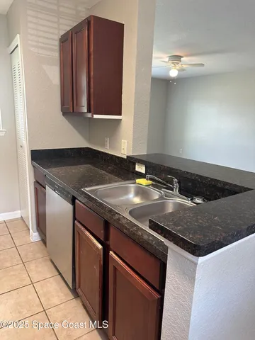 a kitchen with granite countertop a sink and a stove