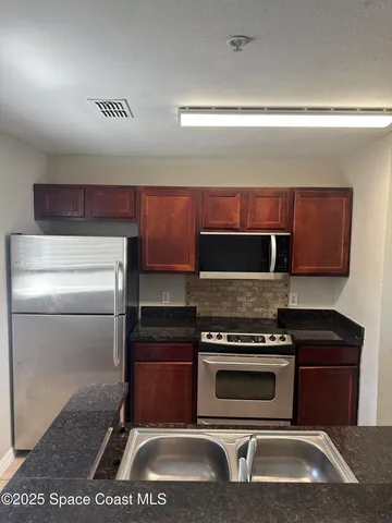 a kitchen with a stove and a microwave