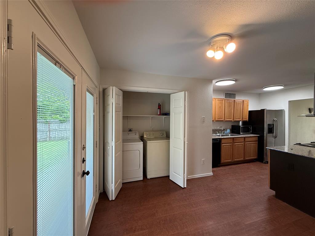 504 Woodcrest Way Forney, TX 75126 - Photo 11 of 26 a view of a kitchen with a refrigerator and a sink
