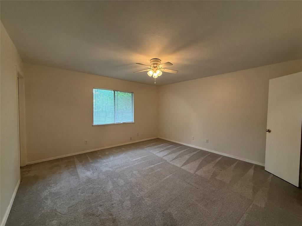 504 Woodcrest Way Forney, TX 75126 - Photo 13 of 26 an empty room with a window and a ceiling fan