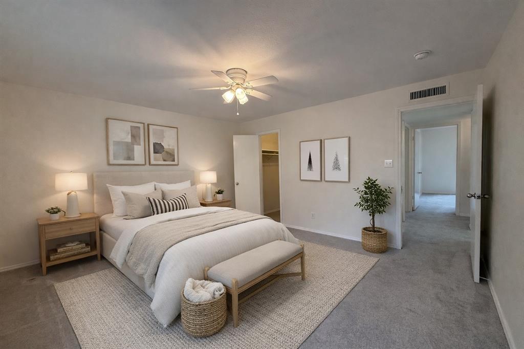 504 Woodcrest Way Forney, TX 75126 - Photo 14 of 26 a bedroom with a large bed and a chandelier