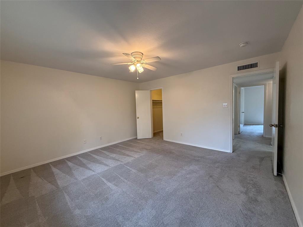 504 Woodcrest Way Forney, TX 75126 - Photo 15 of 26 an empty room with chandelier fan and windows