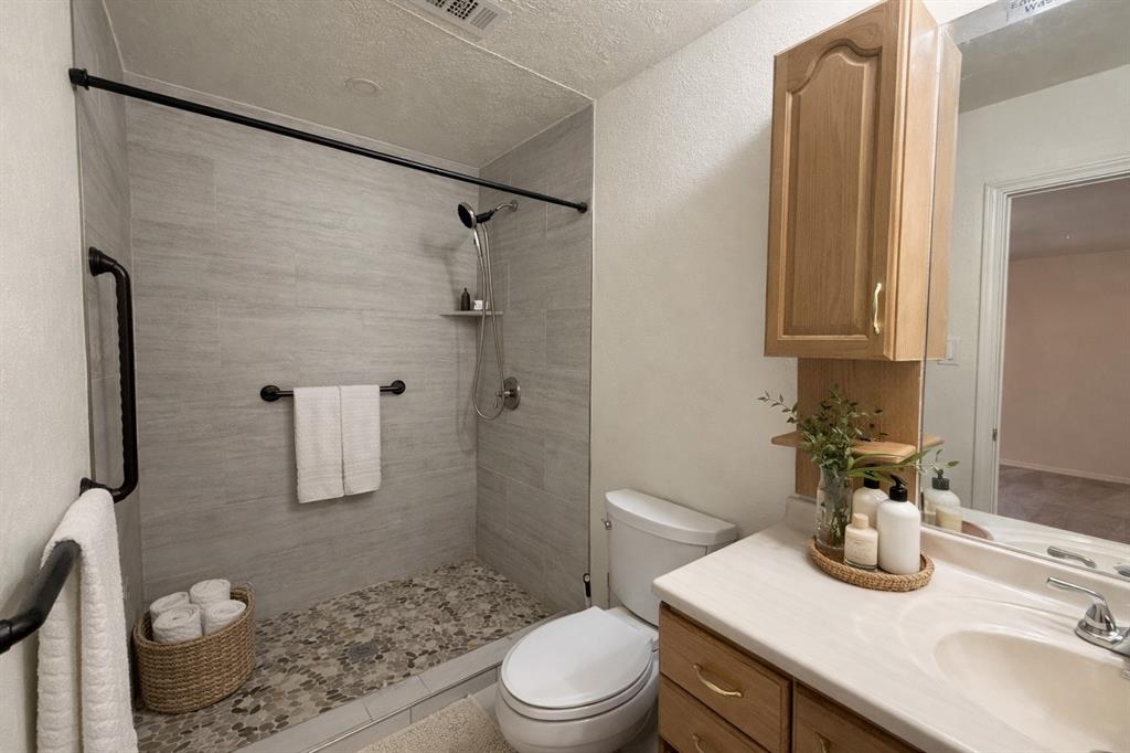 504 Woodcrest Way Forney, TX 75126 - Photo 16 of 26 a bathroom with a sink a toilet and shower