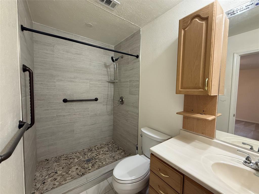 504 Woodcrest Way Forney, TX 75126 - Photo 17 of 26 a bathroom with a sink a toilet and shower
