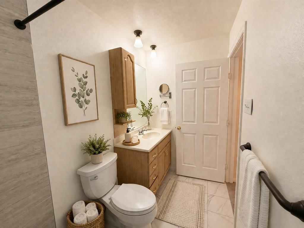 504 Woodcrest Way Forney, TX 75126 - Photo 18 of 26 a bathroom with a toilet a sink and mirror