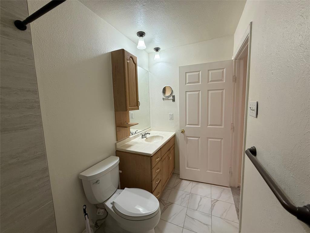 504 Woodcrest Way Forney, TX 75126 - Photo 19 of 26 a bathroom with a toilet sink and mirror