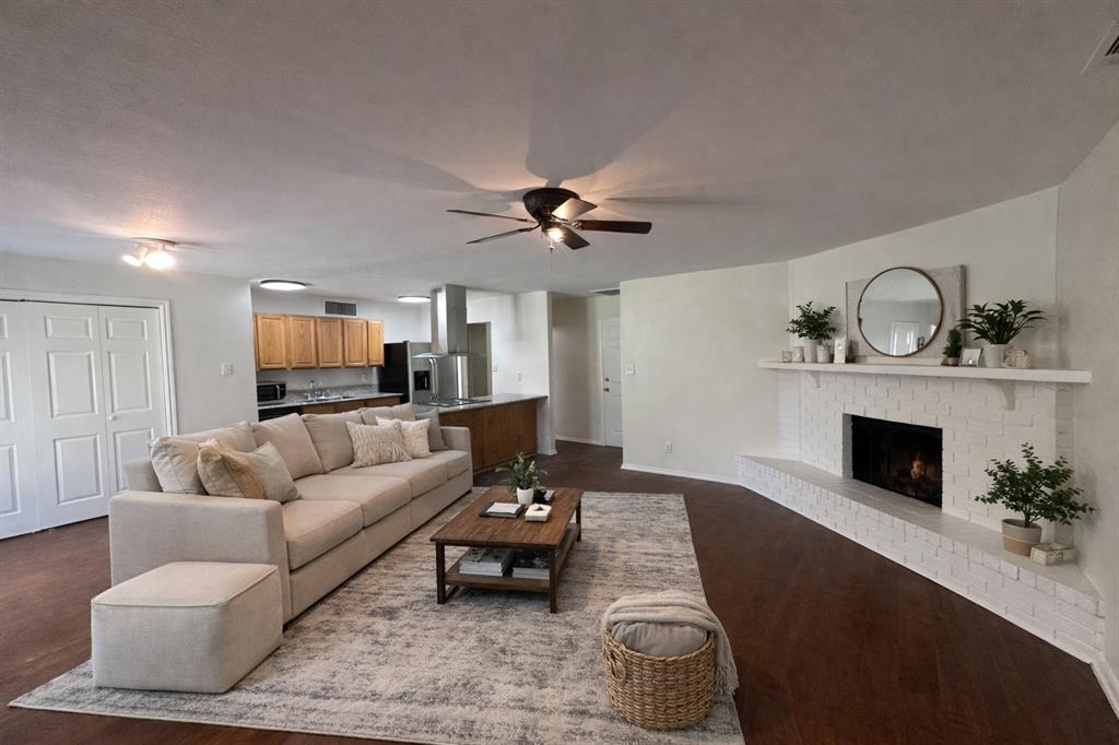 504 Woodcrest Way Forney, TX 75126 - Photo 4 of 26 a living room with furniture and a fireplace