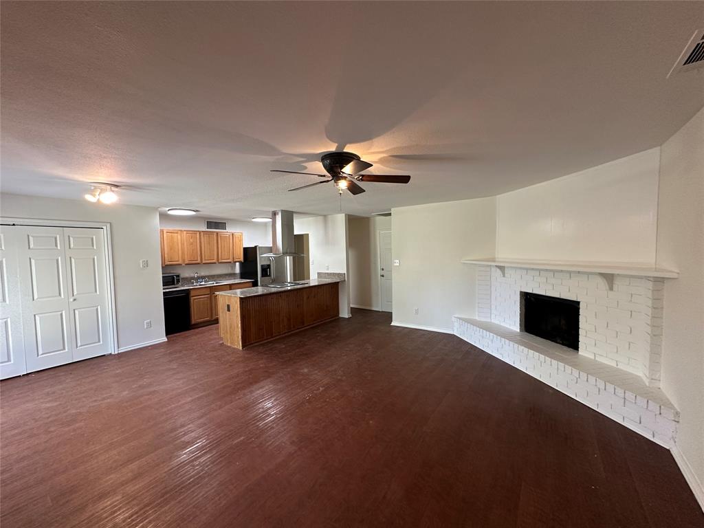 504 Woodcrest Way Forney, TX 75126 - Photo 5 of 26 a view of a kitchen with a sink and a fireplace