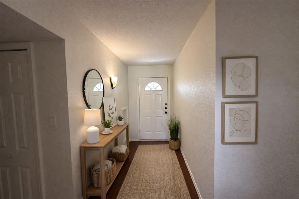 504 Woodcrest Way Forney, TX 75126 - Photo 6 of 26 a view of a hallway with wooden floor and closet