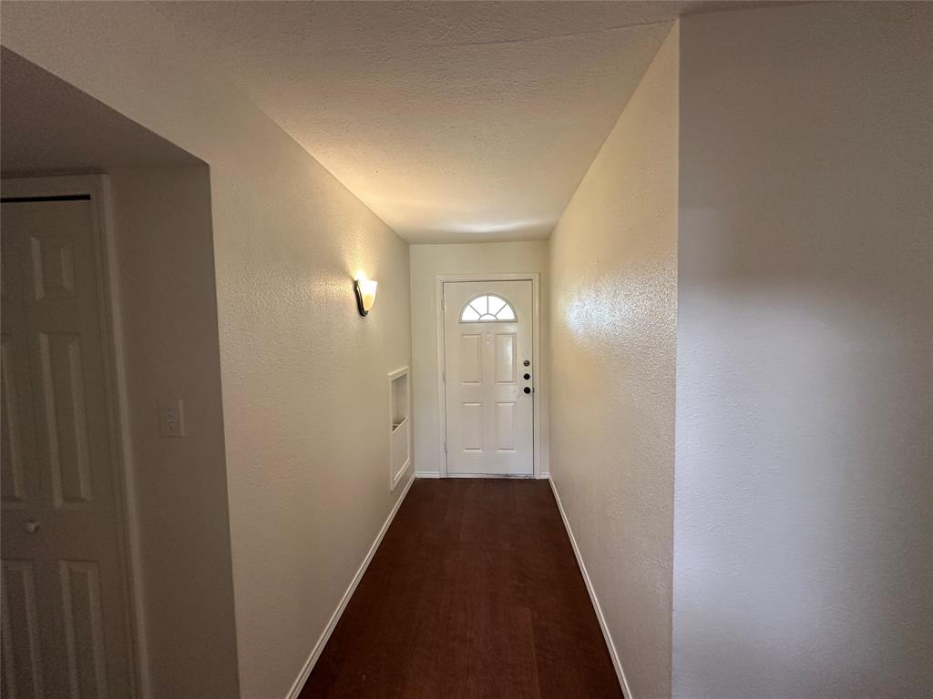 504 Woodcrest Way Forney, TX 75126 - Photo 7 of 26 a view of a hallway with wooden floor