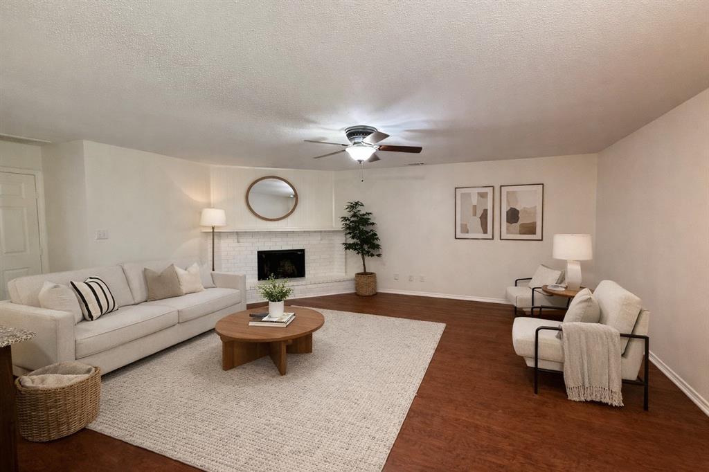 504 Woodcrest Way Forney, TX 75126 - Photo 8 of 26 a living room with furniture a fireplace and a table
