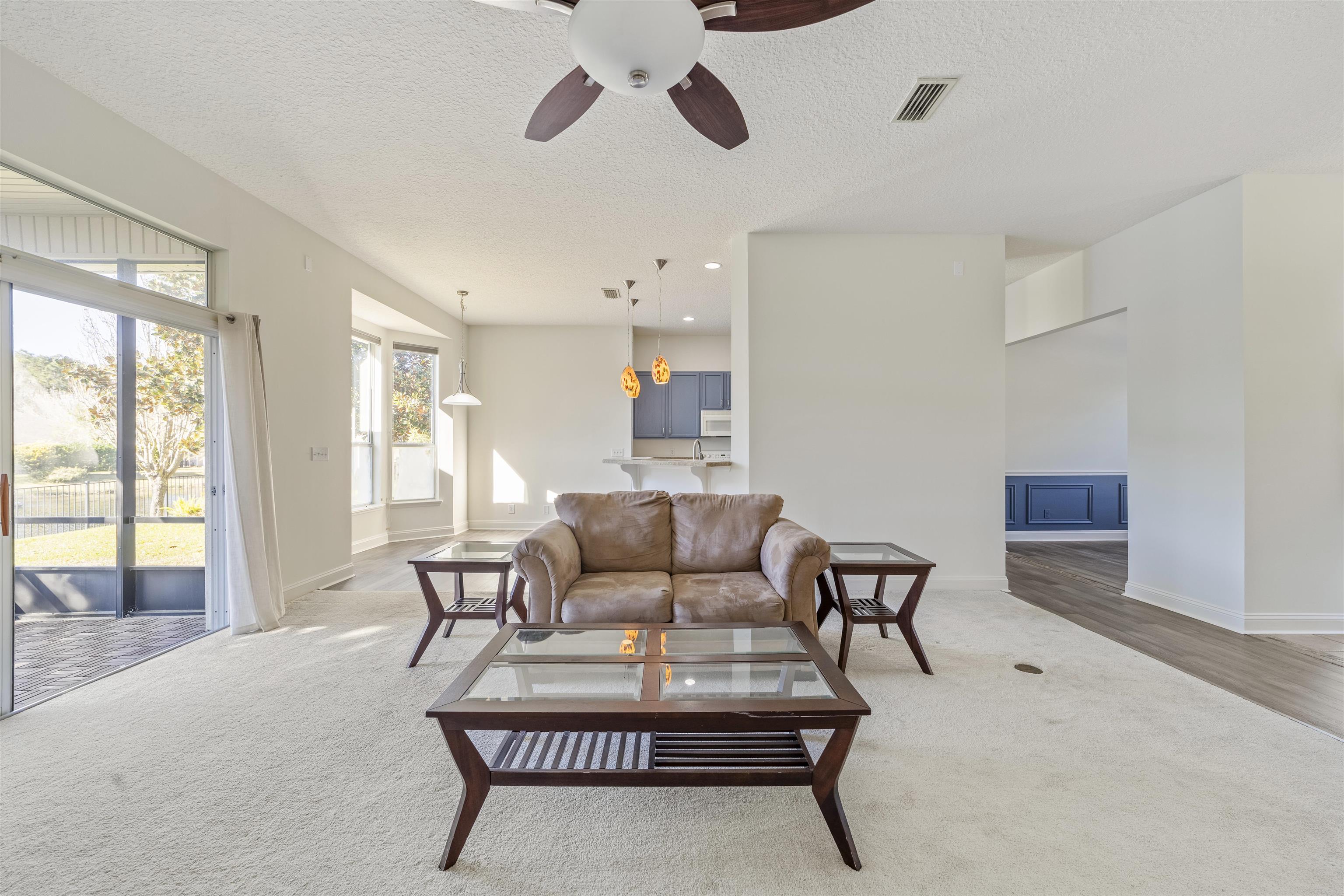 145 Whisper Ridge Drive St. Augustine, FL 32092 - Photo 12 of 32 a living room with furniture and a large window