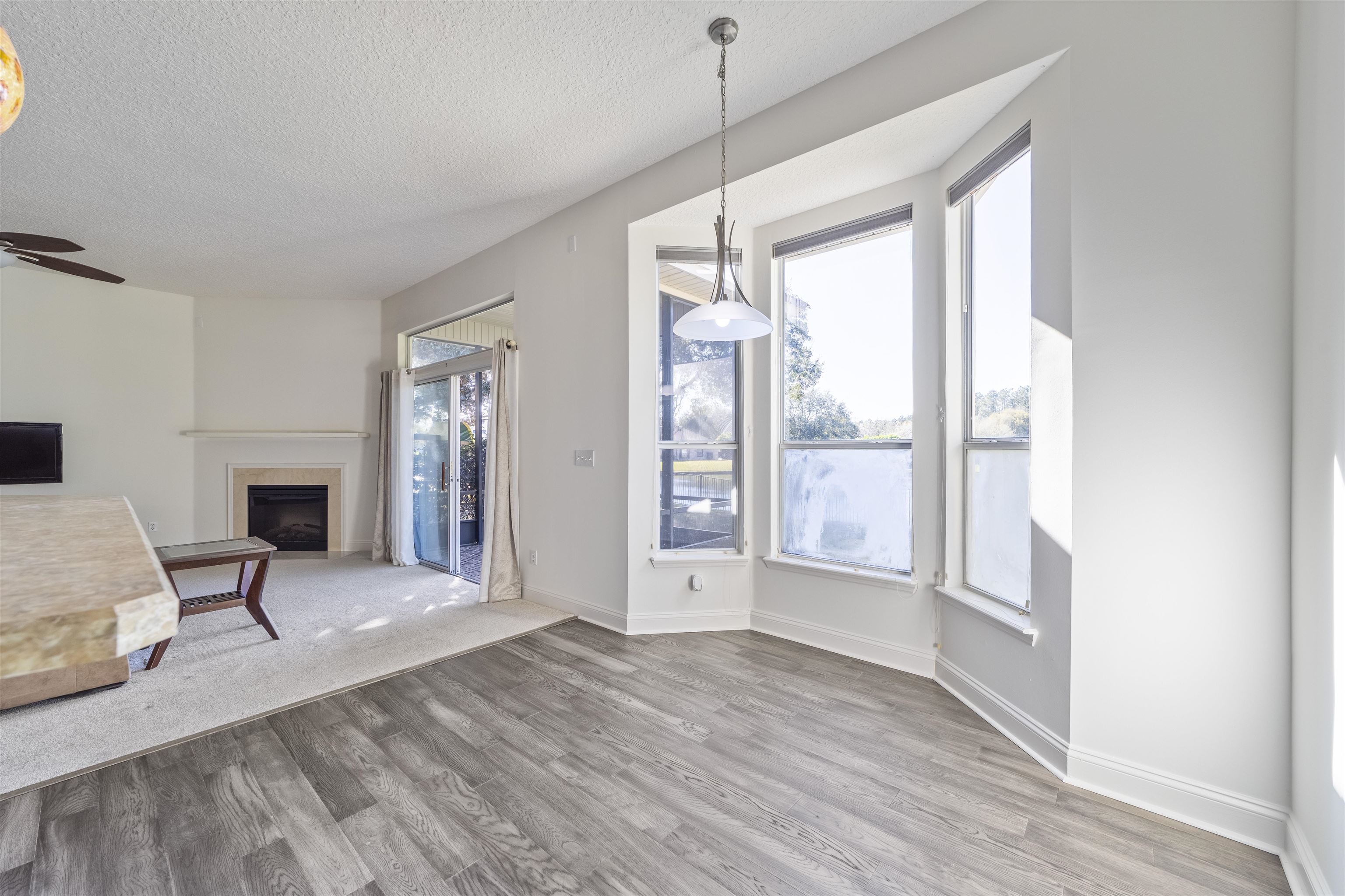 145 Whisper Ridge Drive St. Augustine, FL 32092 - Photo 14 of 32 a view of an empty room with wooden floor and a window