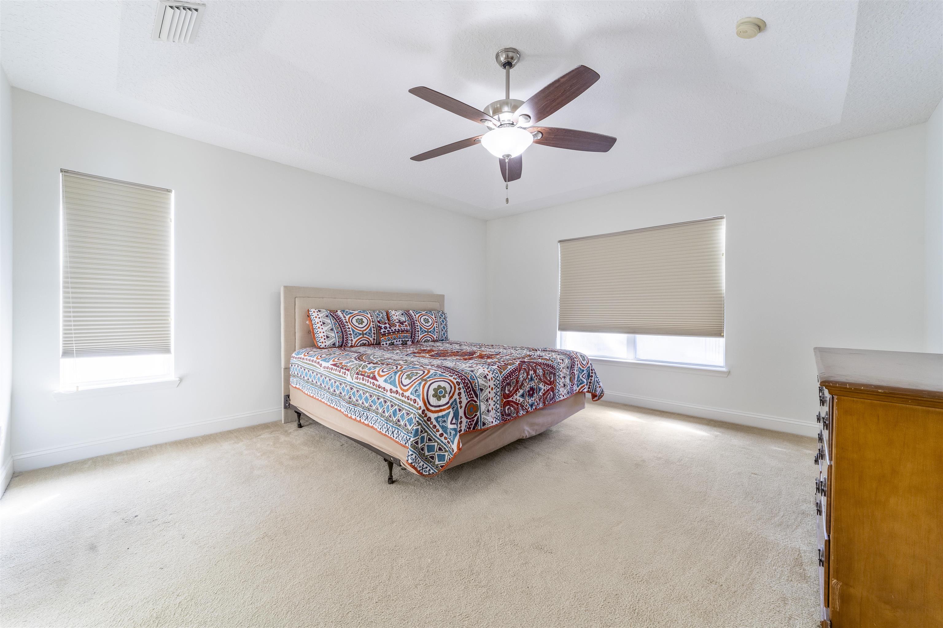 145 Whisper Ridge Drive St. Augustine, FL 32092 - Photo 20 of 32 a bedroom with a bed and window