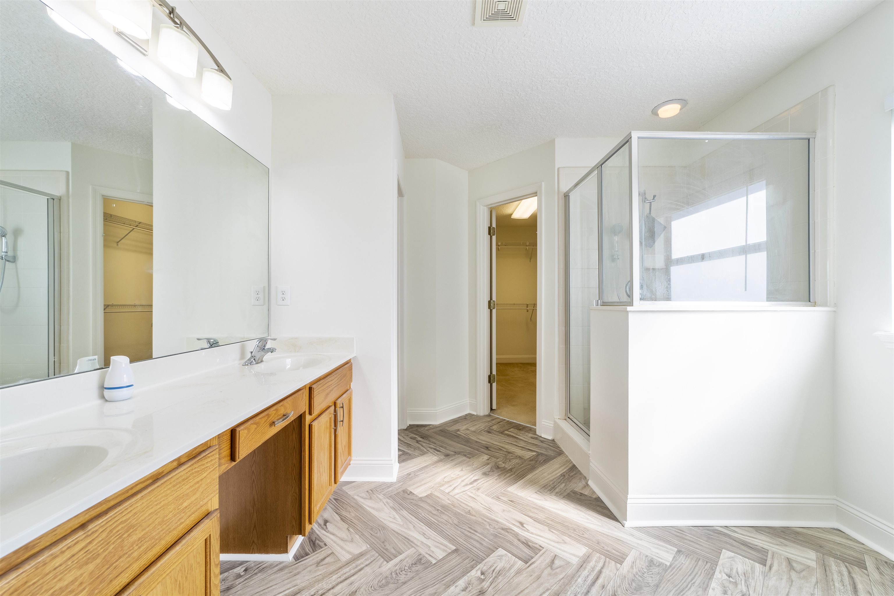 145 Whisper Ridge Drive St. Augustine, FL 32092 - Photo 22 of 32 a bathroom with a sink and a mirror