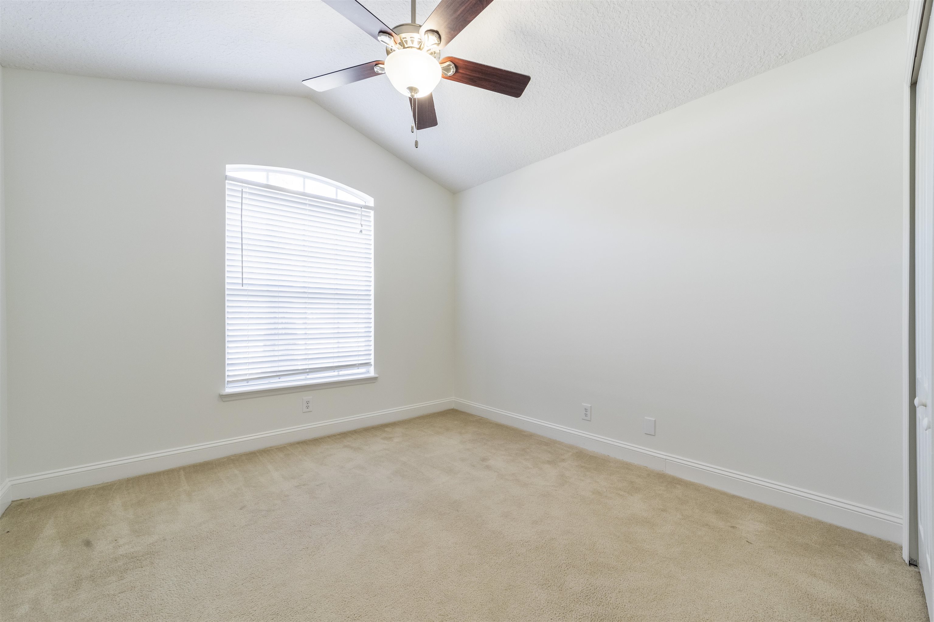 145 Whisper Ridge Drive St. Augustine, FL 32092 - Photo 25 of 32 an empty room with a window and a fan
