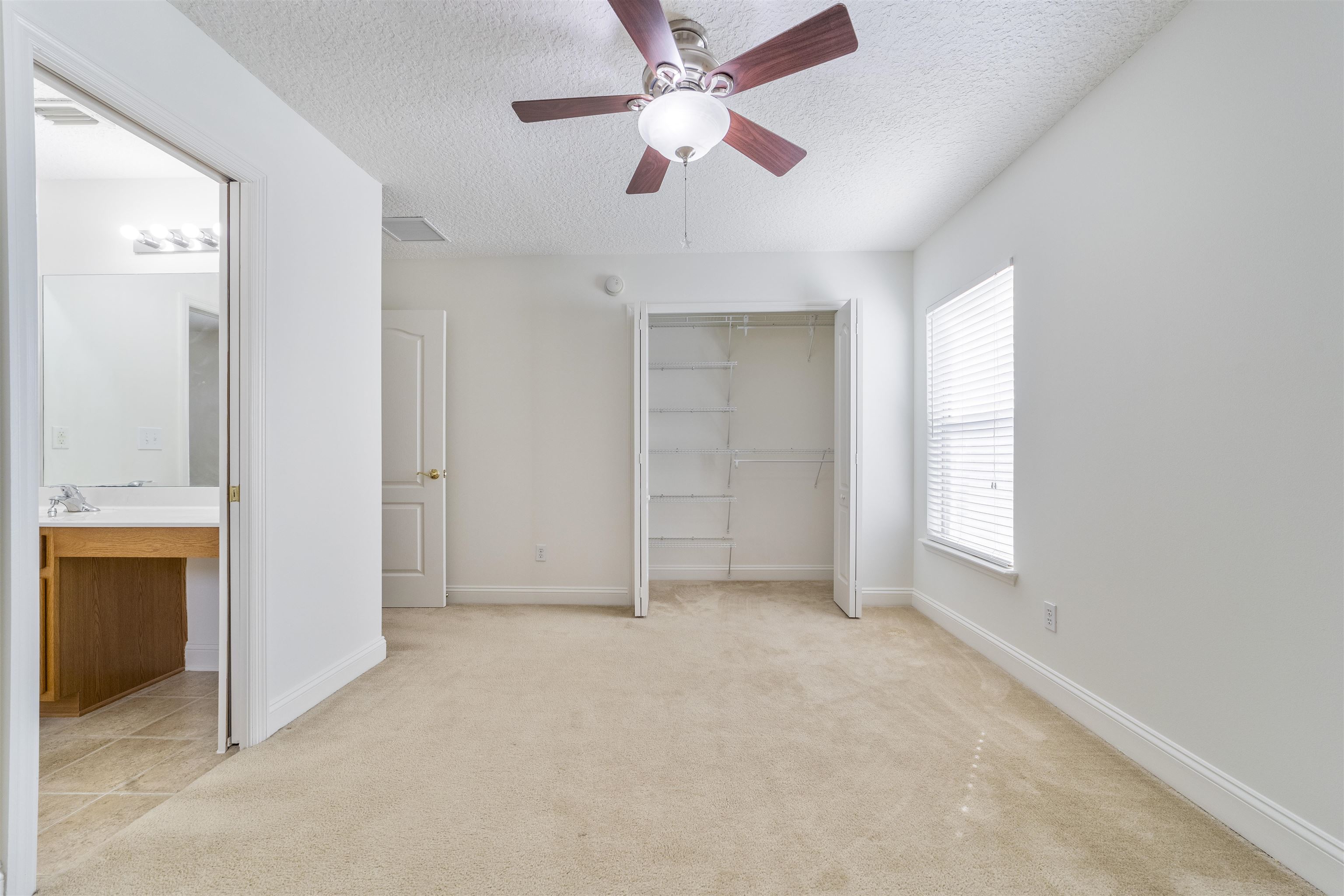 145 Whisper Ridge Drive St. Augustine, FL 32092 - Photo 27 of 32 an empty room with closet and a ceiling fan